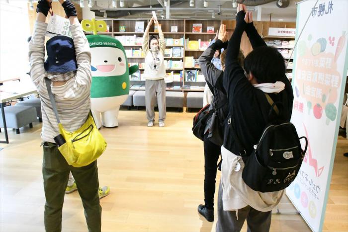 ウオーキング前に準備運動をする参加者たちと中ウォークん