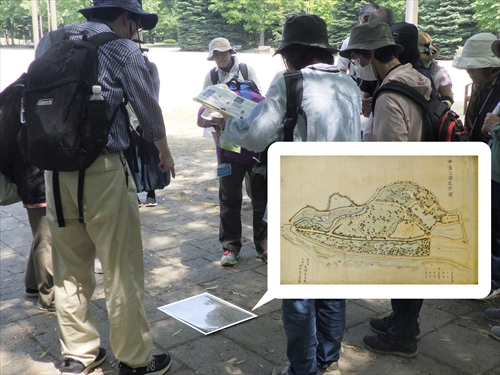 中島公園設計図を眺めるツアー参加者の様子