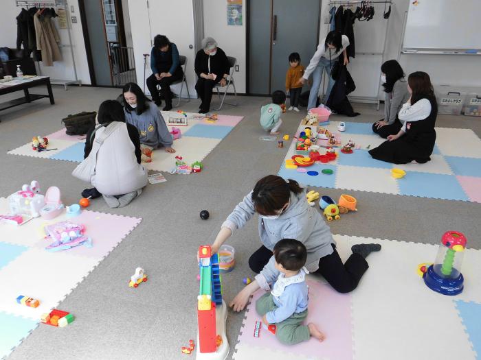 5組の親子とスタッフがおもちゃなどで遊んでいる様子
