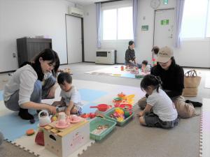 ままごとセットで遊んでいる親子の様子