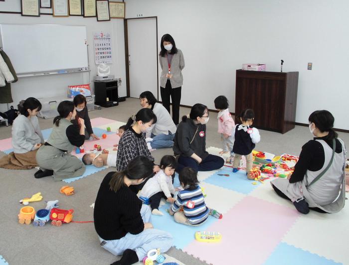 子どもたちを遊ばせながら会話を楽しんでいる保護者たちの様子