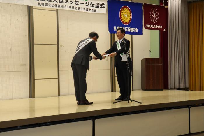 森会長から佐藤北区長へメッセージ状を渡す