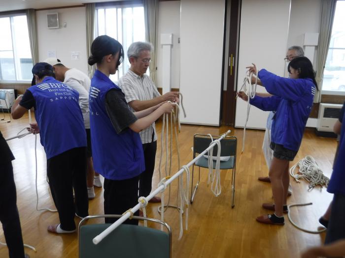 ロープワークを指導する中高生クラブ員
