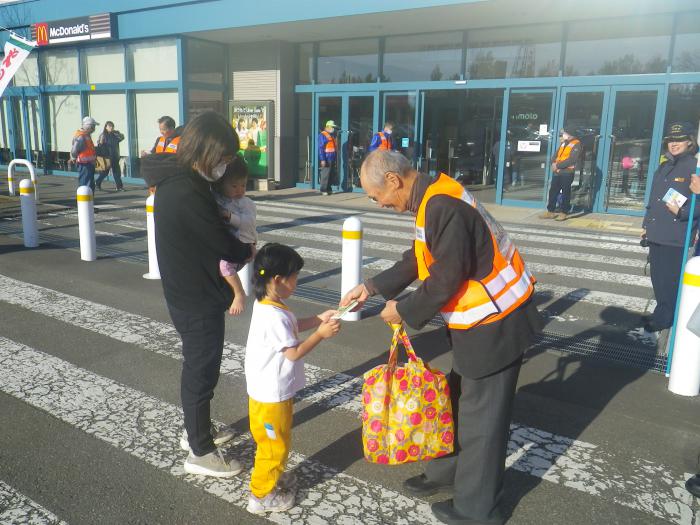 防火委員が子供にティッシュを渡している様子